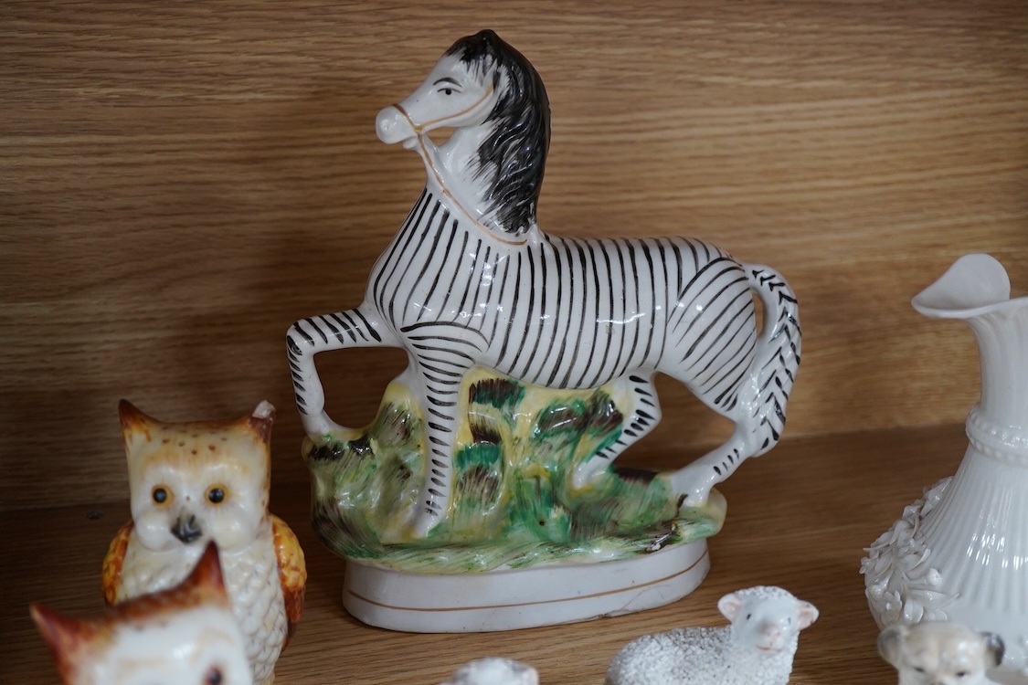 A pair of Worcester 'owl' candle snuffers, Staffordshire Zebra and two sheep, Belleek etc zebra 19cm wide.